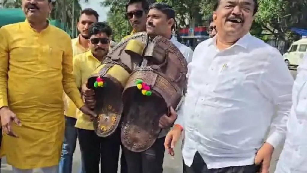 1. A group of men in yellow and white shirts holds up a pair of shoes, symbolizing protest and unity in their cause. 2. Men in yellow and white shirts display a pair of shoes, representing a collective stand against an issue. 3. A diverse group of men in yellow and white shirts proudly holds a pair of shoes, conveying a message of 1. A group of men in yellow and white shirts holds up a pair of shoes, symbolizing protest and unity in their cause. 2. Men in yellow and white shirts display a pair of shoes, representing a collective stand against an issue. 3. A diverse group of men in yellow and white shirts proudly holds a pair of shoes, conveying a message of विरोध and solidarity.and solidarity.